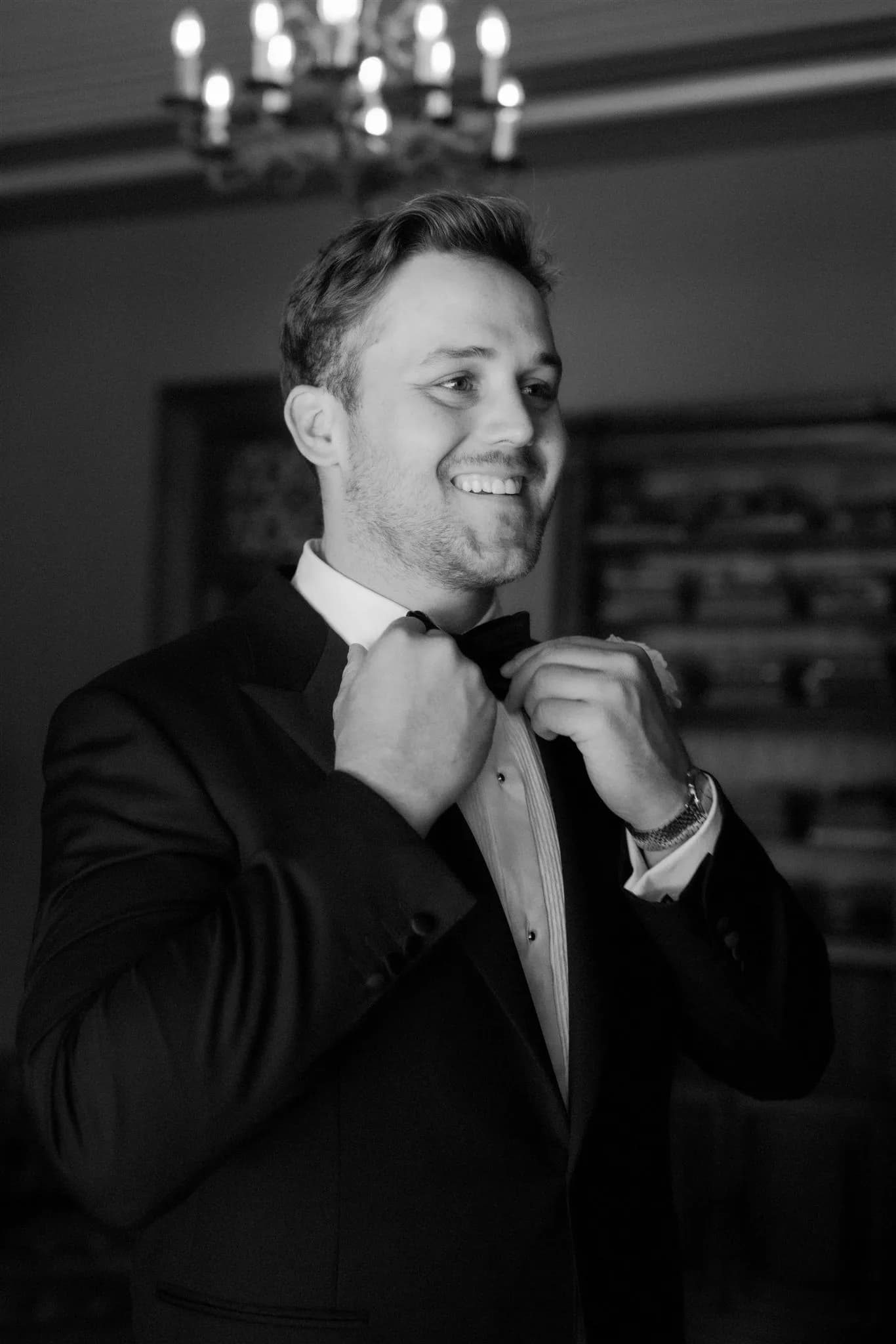Groom doing up bowtie
