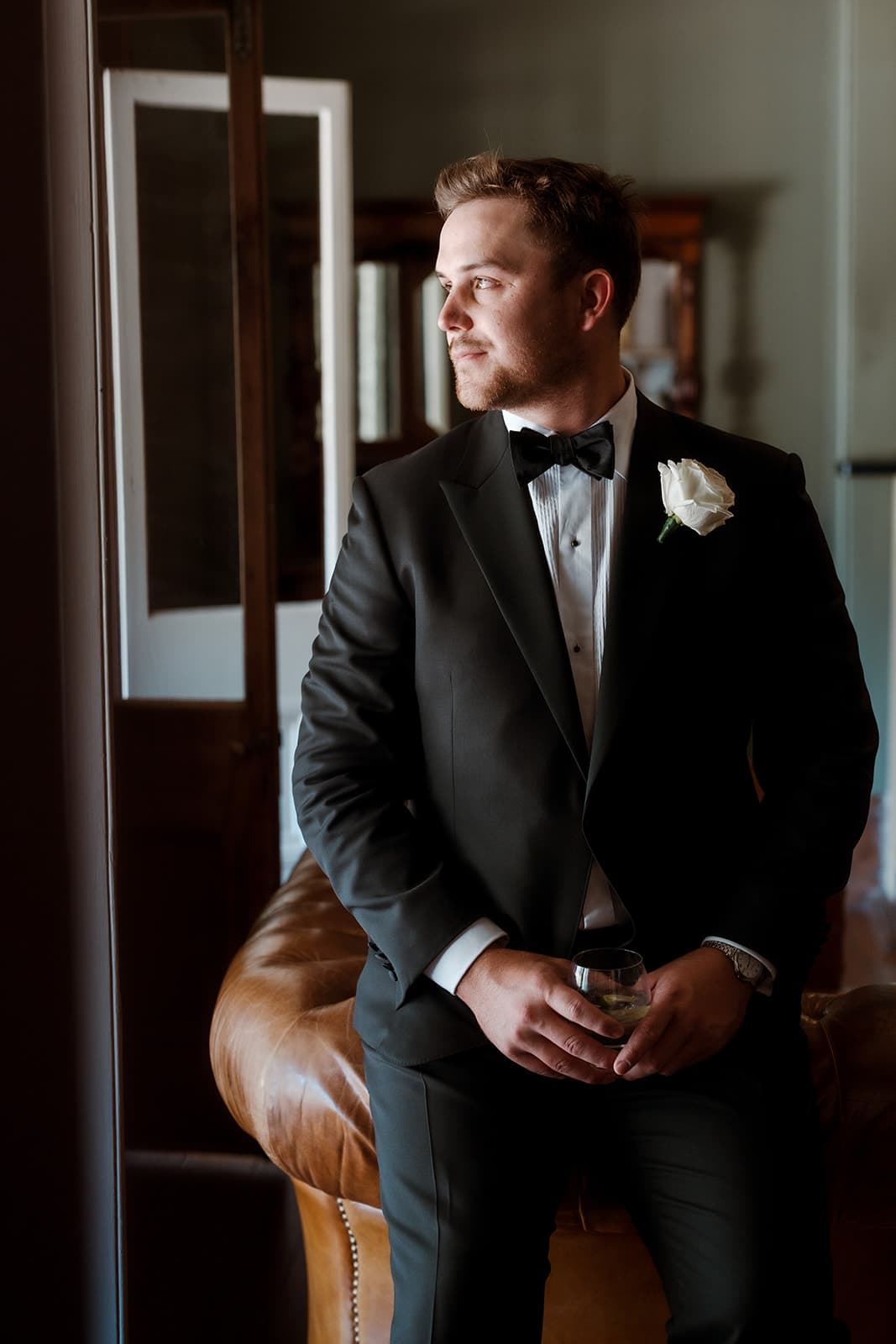 Groom sitting on leather lounge