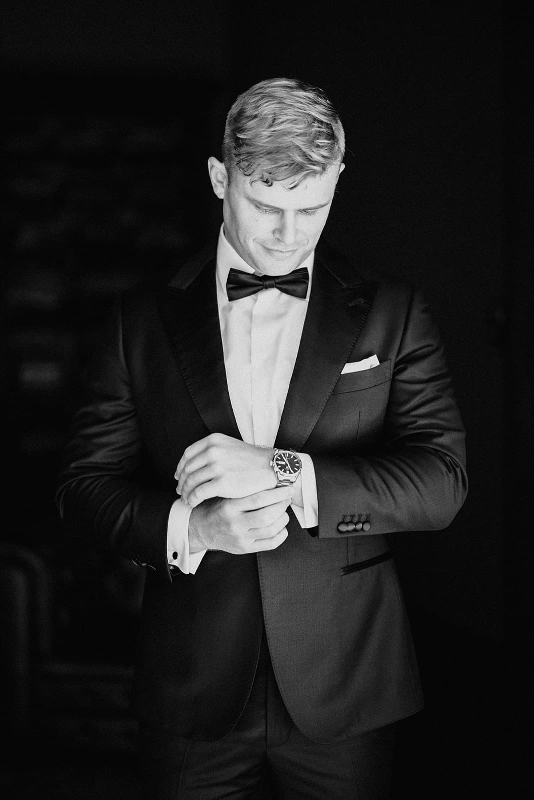 Groom adjusting watch