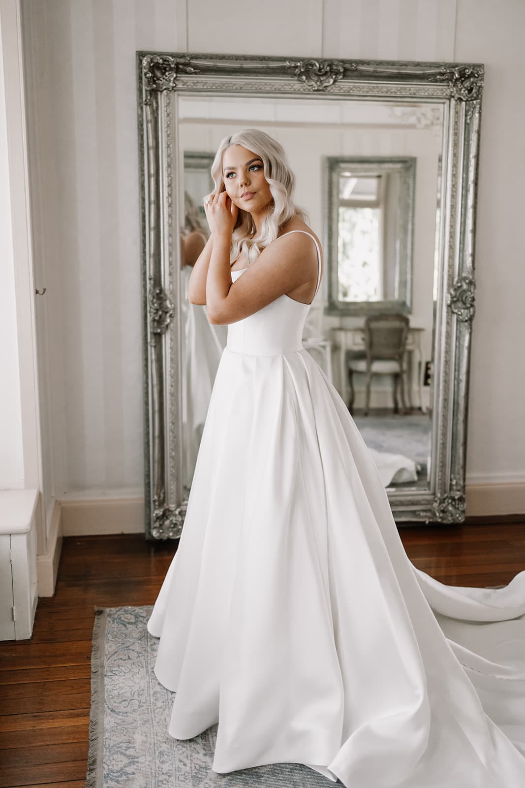 Bride putting earrings in