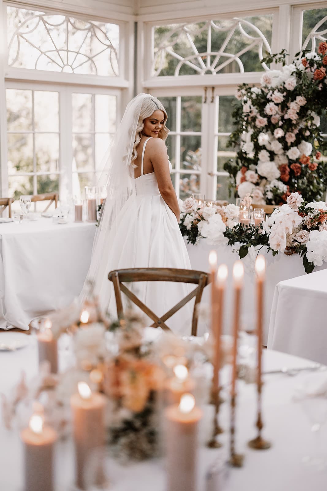 Bride walking through reception room
