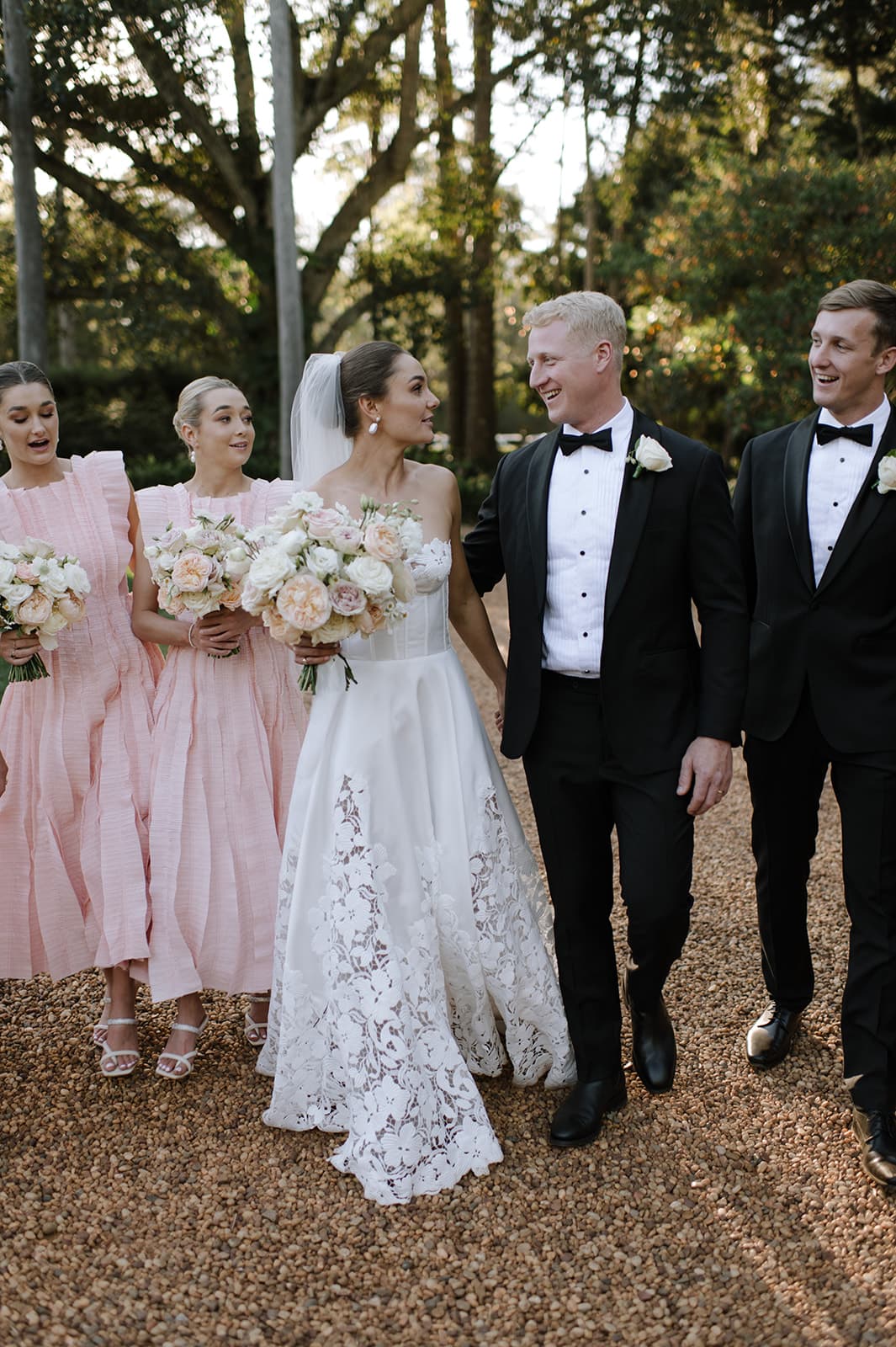 the wedding party posing for photographs outside at gabbinbar