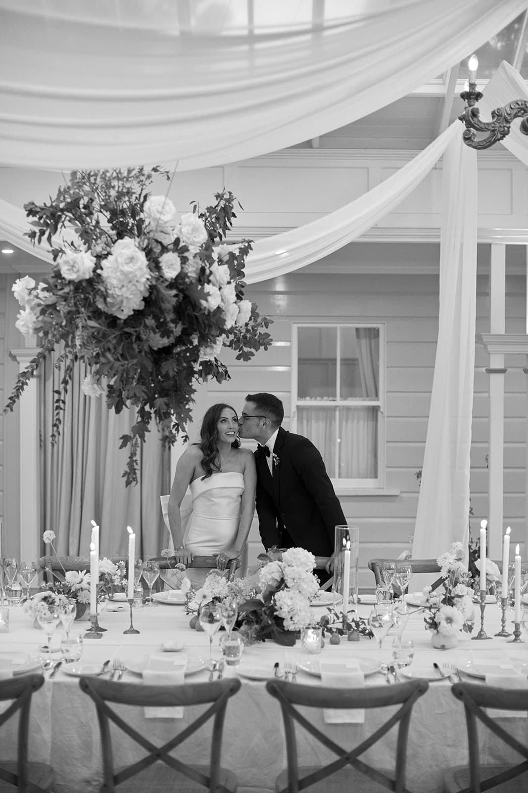 Couple look up at ceiling in conservatory